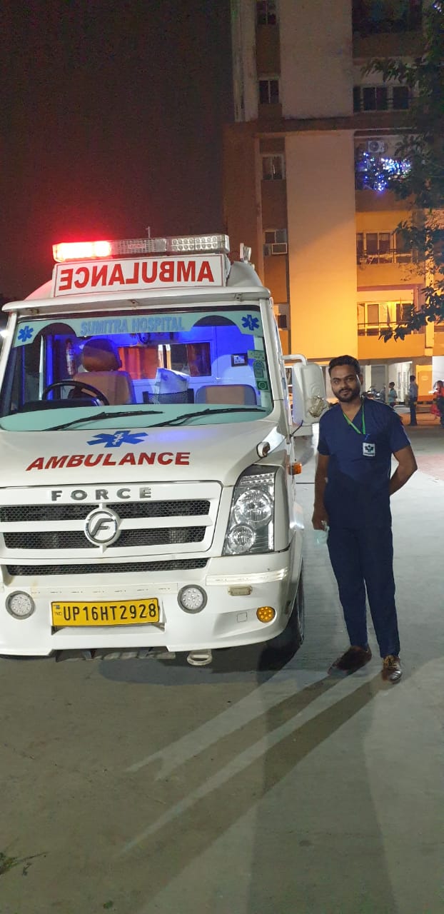 Nursing staff member standing next to an ambulance